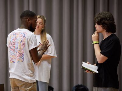 Image of one person directing two actors